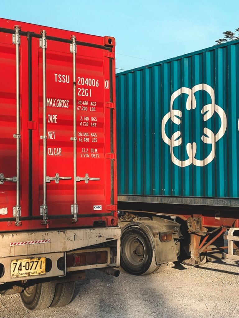 Freight containers secured on a trailer for cargo transport.