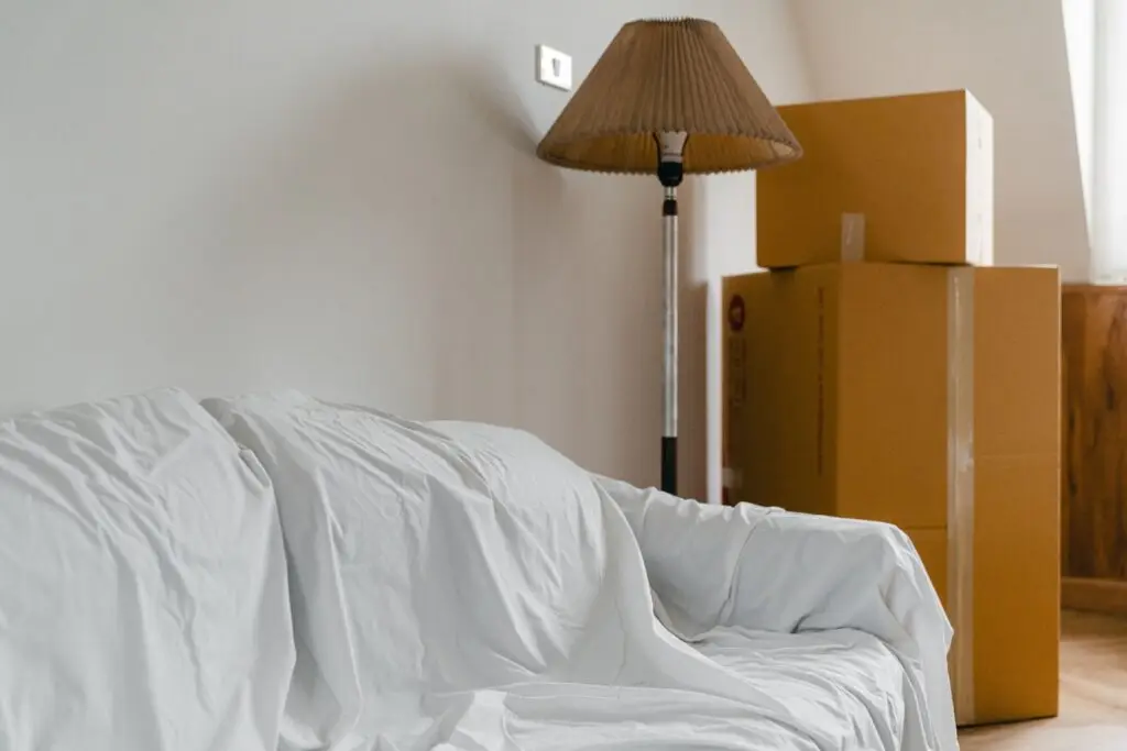 Sofa covered and moving cartons arranged for a home move in Dubai.