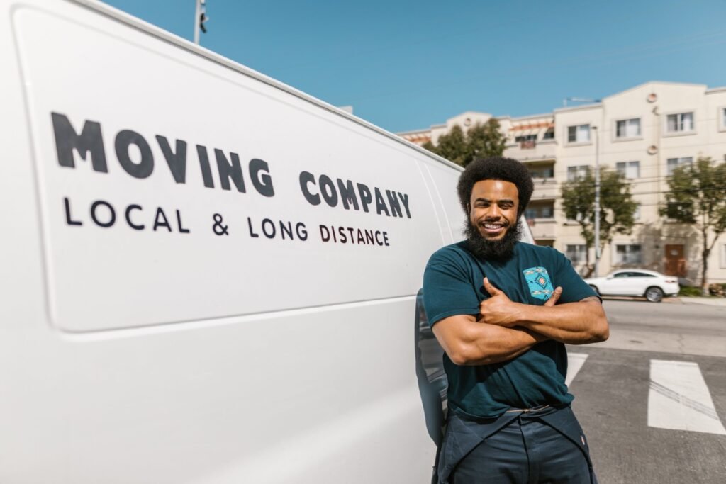 Mover standing beside a moving van in Dubai.
